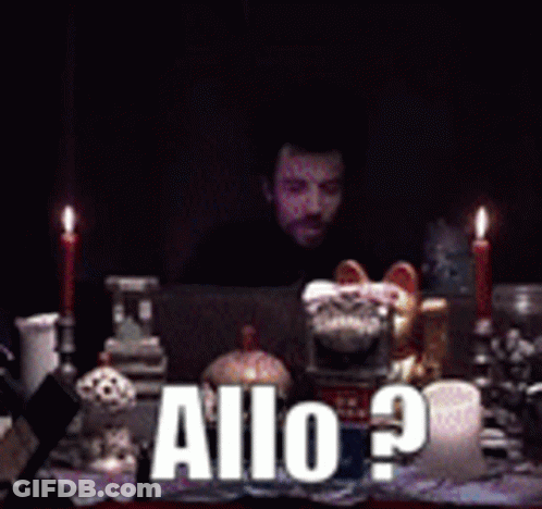 Man Sitting At Table With Candles And Allo Sign GIF