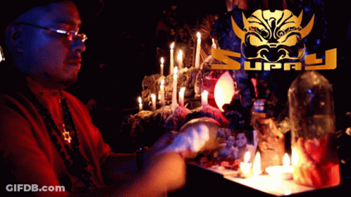 Man Sitting At Table With Candles And Supply Logo GIF