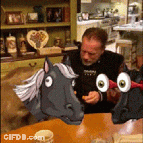 Man Sitting At Table With Cartoon Horse Head GIF