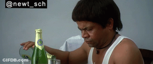 Man Sitting At Table With Champagne And Sign Saying @Newt_sch GIF