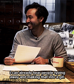 Man Sitting At Table With Coffee Mug And Paper GIF