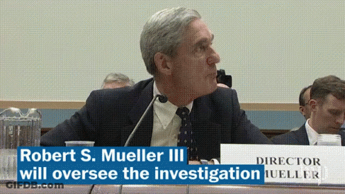 Man Sitting At Table With Director Sign GIF