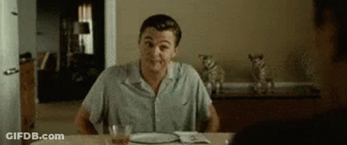 Man Sitting At Table With Food And Alcohol GIF