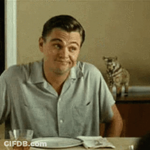 Man Sitting At Table With Food And Cat GIF