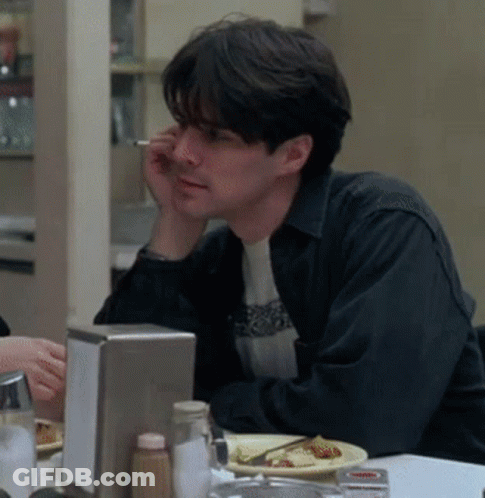 Man Sitting At Table With Food And Cigarette GIF