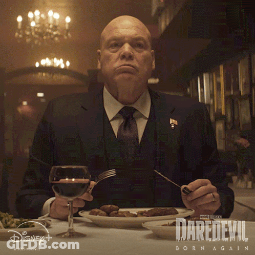 Man Sitting At Table With Food And Wine GIF
