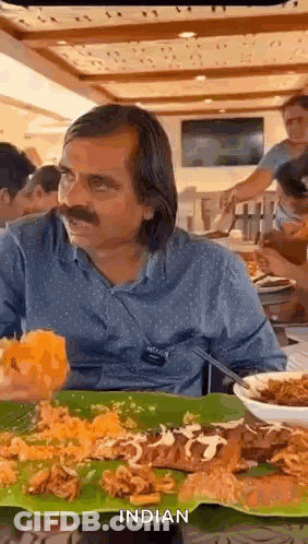 Man Sitting At Table With Food GIF