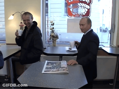Man Sitting At Table With Frankfurt Newspaper GIF