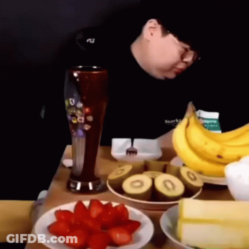 Man Sitting At Table With Fruit And Beer GIF