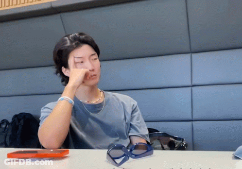 Man Sitting At Table With Hand On Face GIF