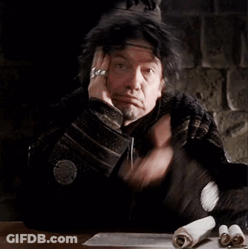 Man Sitting At Table With Hand On Head GIF