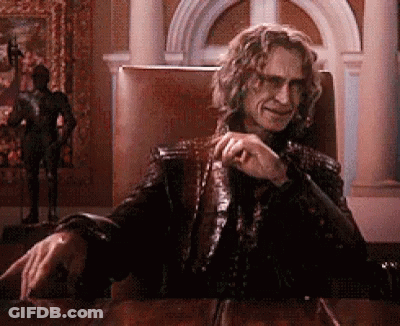 Man Sitting At Table With Hand On Knee GIF