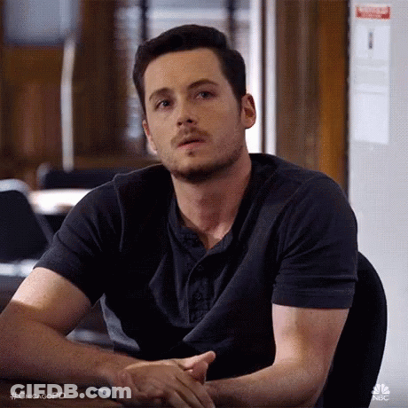 Man Sitting At Table With Hands Folded GIF