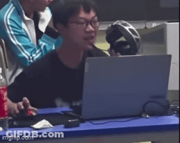Man Sitting At Table With Laptop And Headphones GIF
