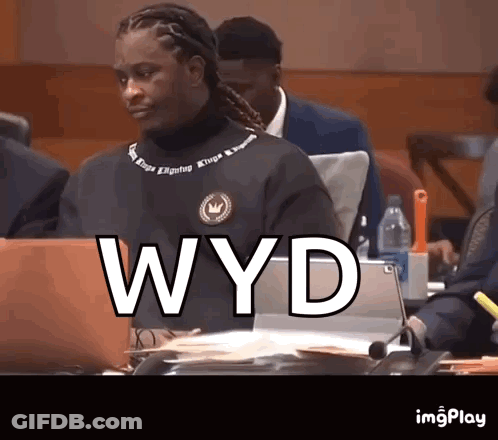 Man Sitting At Table With Laptop Saying WYD GIF