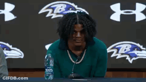 Man Sitting At Table With Microphone And Water GIF