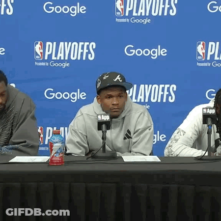 Man Sitting At Table With Microphones GIF