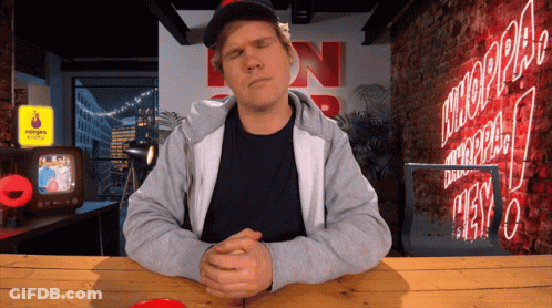Man Sitting At Table With N Sign GIF