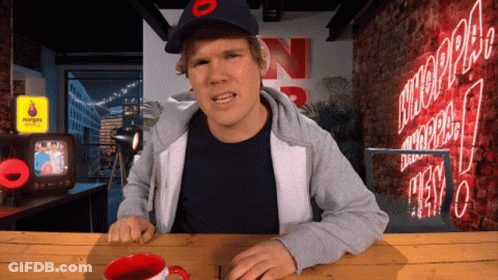 Man Sitting At Table With N Sign GIF