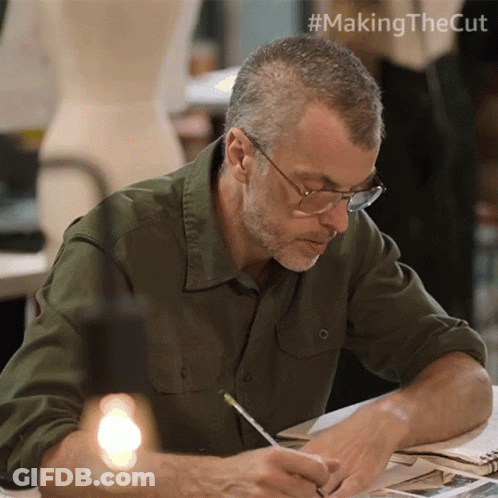 Man Sitting At Table With Pencil GIF