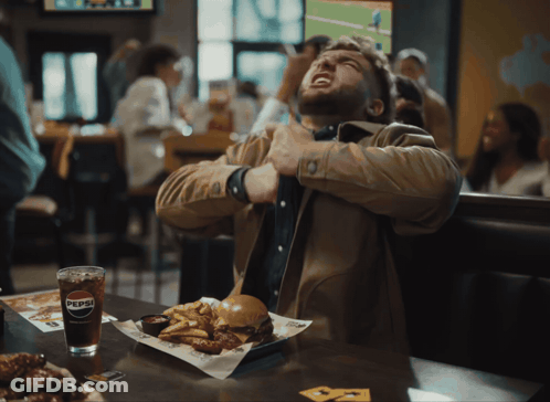Man Sitting At Table With Pepsi And Food GIF