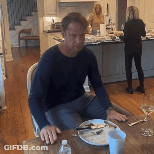Man Sitting At Table With Plate Of Food GIF