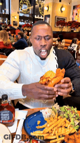 Man Sitting At Table With Plate Of Food And Maple Syrup GIF