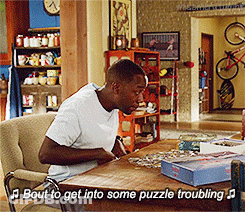 Man Sitting At Table With Puzzles Saying Bout To Get Into Some Puzzle Troubling GIF