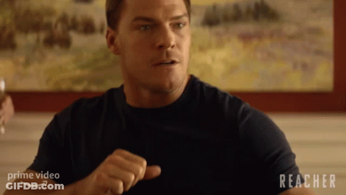 Man Sitting At Table With Reacher GIF