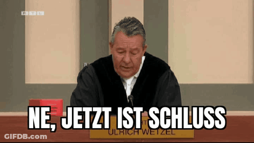 Man Sitting At Table With Schluss Words GIF