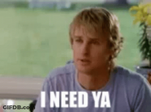 Man Sitting At Table With Sign Saying I Need Ya GIF
