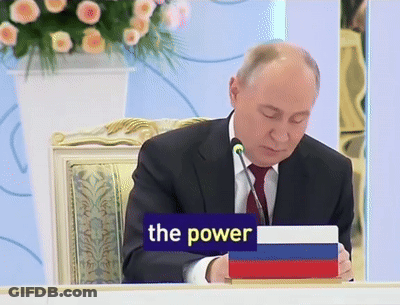 Man Sitting At Table With Sign Saying The Power GIF