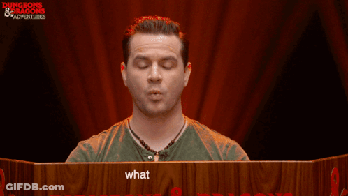 Man Sitting At Table With Sign Saying What Are You Doing GIF