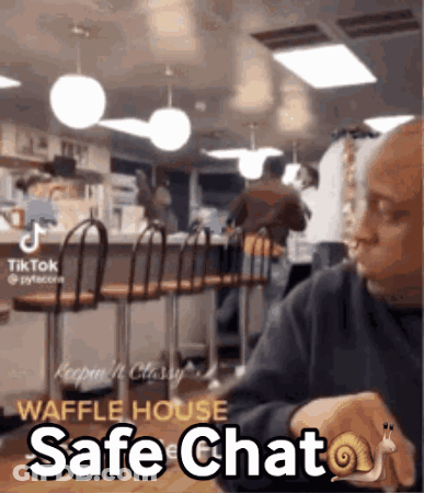 Man Sitting At Table With Snail On Wrist Saying Safe Chat GIF