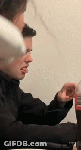 Man Sitting At Table With Soda GIF
