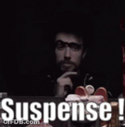 Man Sitting At Table With Suspense Sign GIF