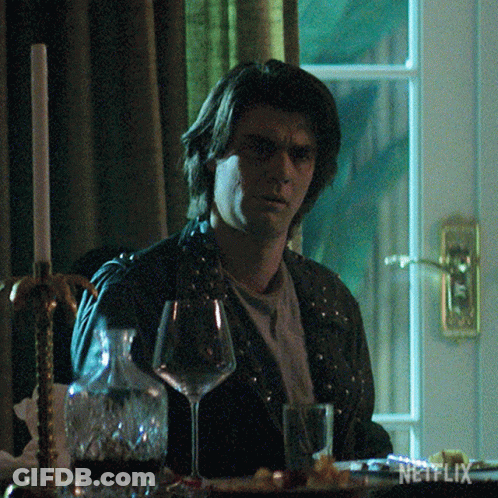Man Sitting At Table With Wine And Netflix GIF