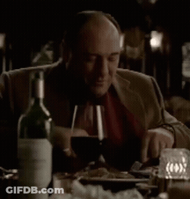 Man Sitting At Table With Wine Bottle GIF