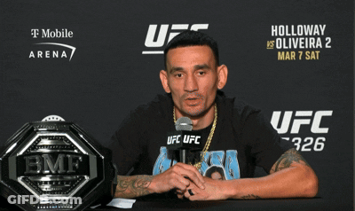 Man Sitting At UFC Sign GIF