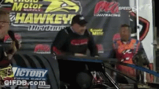 Man Sitting At Victory Sign GIF