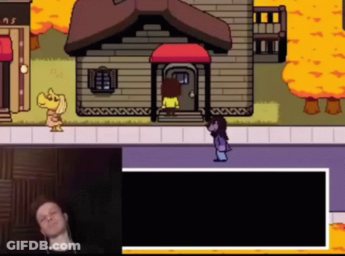Man Sitting At Video Game Screen With Woman Standing In Front Of House GIF