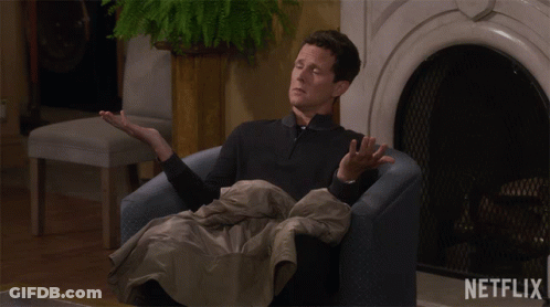 Man Sitting By Fireplace With Netflix Logo GIF