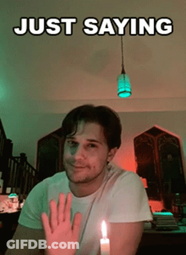 Man Sitting By Lit Candle Saying Just GIF