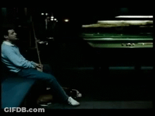 Man Sitting By Pool Table With Cue GIF