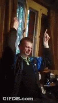 Man Sitting By Window With Hands In Air GIF