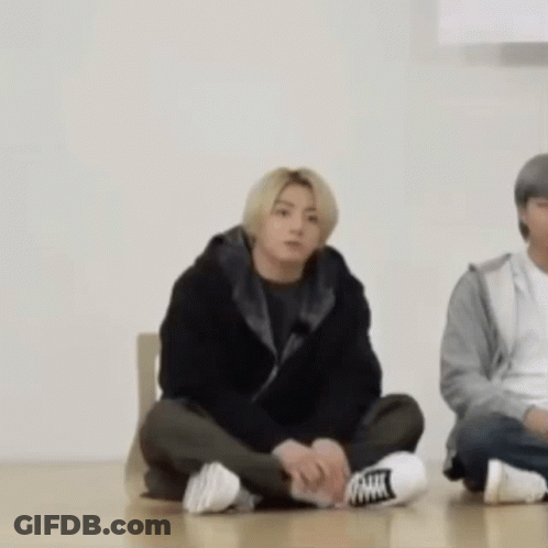 Man Sitting Cross-Legged Next To Woman GIF