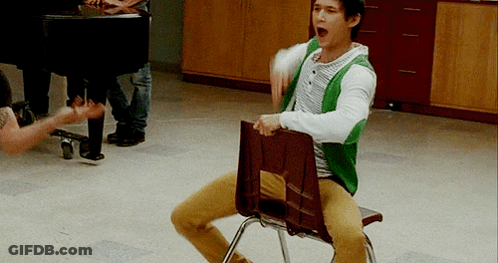 Man Sitting Cross-Legged On Chair GIF