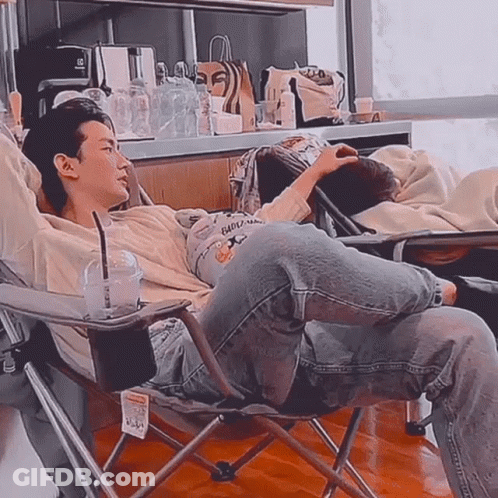 Man Sitting Cross-Legged With Coffee GIF