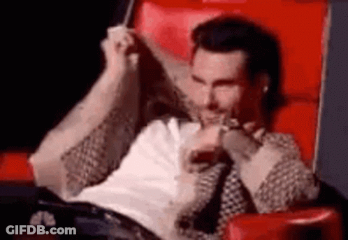 Man Sitting Crossed Legs In Red Chair GIF