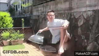 Man Sitting Crossed Legs On Grill With Wooden Stick GIF